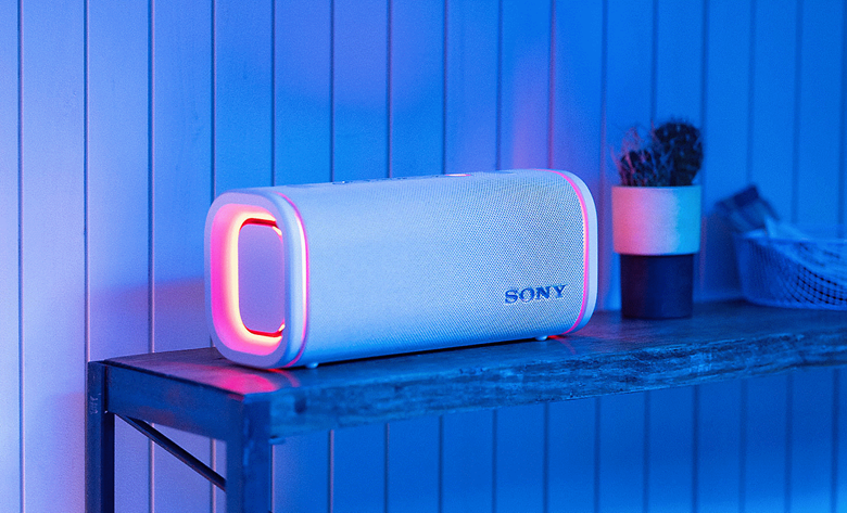 The white ULT FIELD 5 speaker laying horizontally on a side table