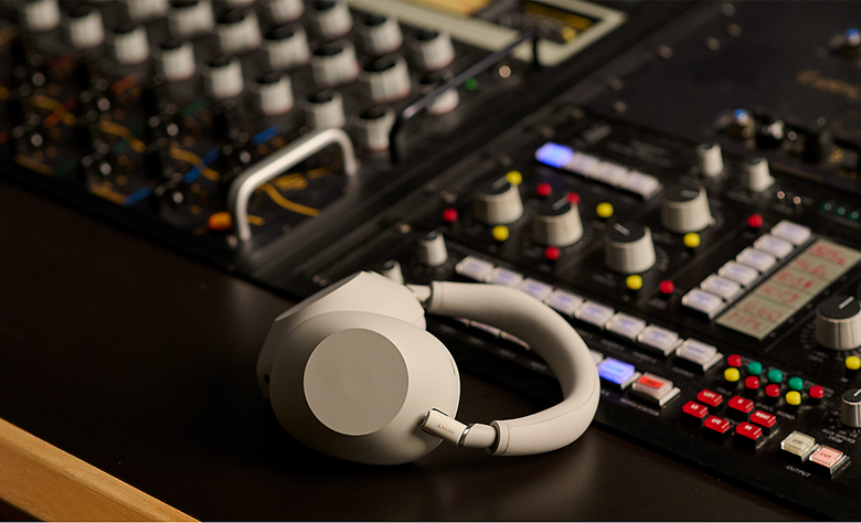 WH-1000XM6 headphones placed on an audio mixing console in a studio.
