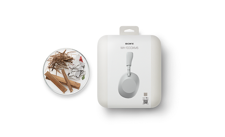 WH-1000XM6 headphones' packaging made from recycled materials, displayed next to raw recycled fibres from wood and paper.