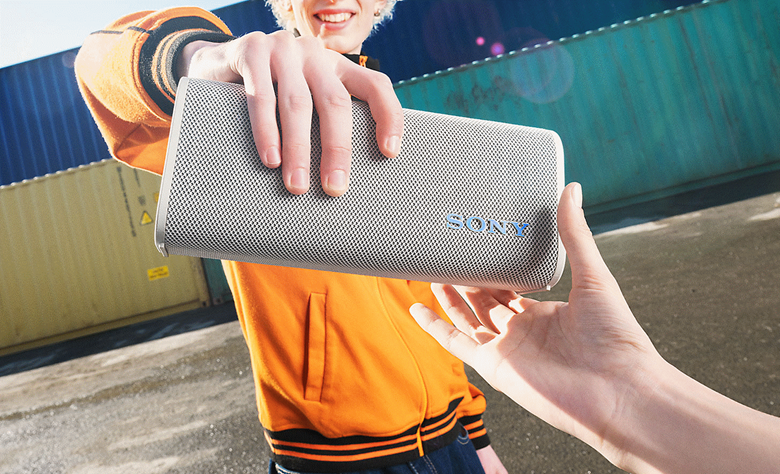 One person placing the ULT FIELD 3 speaker into their friends hand