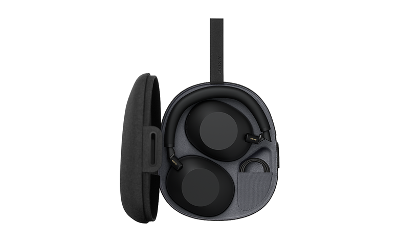 Compact carrying case with magnetic closure, storing folded WH-1000XM6 headphones and a cable.
