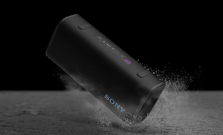 The ULT FIELD 3 is dropped in sand showing dust and water droplets falling on the product