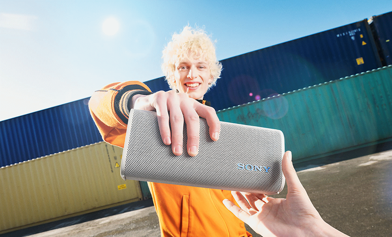 One person placing the ULT FIELD 3 speaker into their friends hand